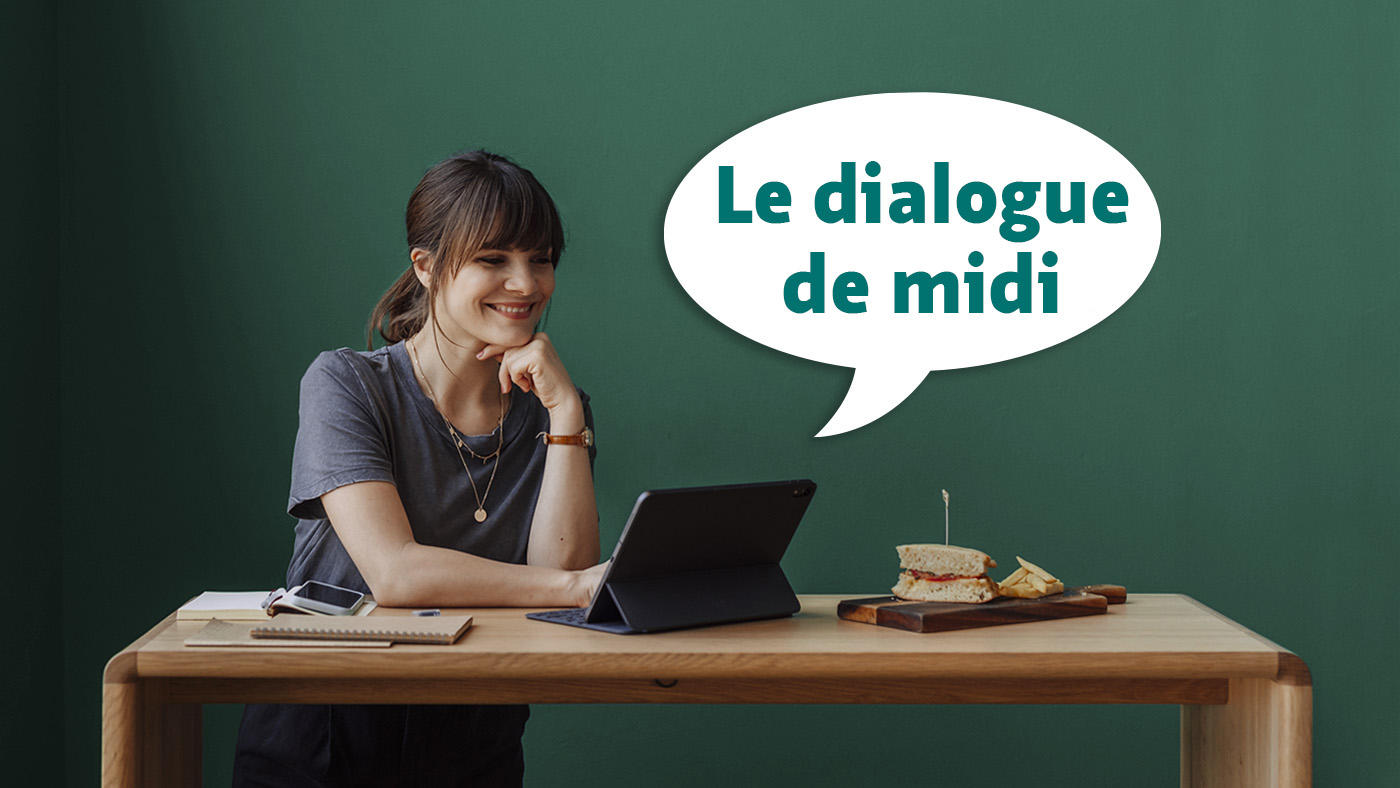 Une femme est assise à une table devant un ordinateur